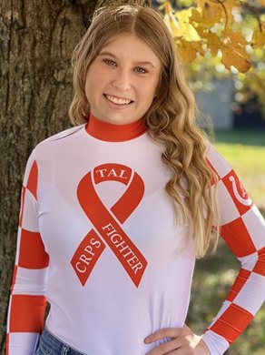 Taylor Logan wears TEC Racing's orange silk shirt to spread awareness of complex regional pain syndrome (CRPS) in her senior photo
