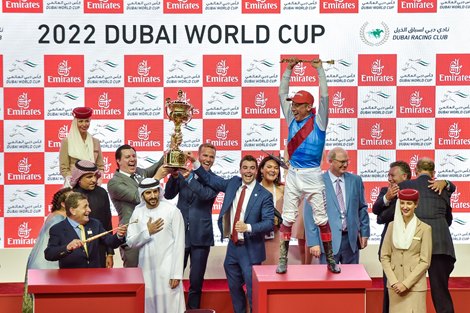 Holding the 2022 Dubai World Cup trophy (L-R)  are Commonwealth co-founder Chase Chamberlin, CEO Brian Doxtator, and Preston Troutt, son of Winstar Farm owner Kenny Troutt.