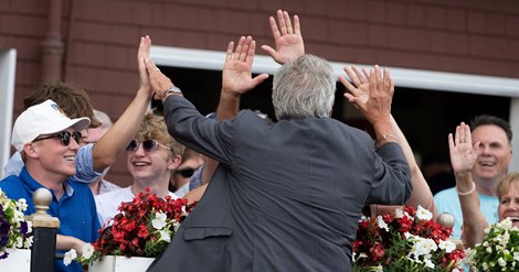 Becky's Joker trainer gives race fans hearty punches after she won the 105th The Schuylerville run on opening day at Saratoga Racecourse on July 13, 2023 in Saratoga Springs, NY Skip Dickstein's photo