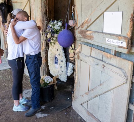 Trainer Melanie Giddings hugs Maple Leaf Mel’s groom after receiving the blanket of flowers from the Test Stakes where she lost her life at the Saratoga Race Course Sunday, Aug. 6, 2023 in Saratoga Springs, N.Y. Photo  by Skip Dickstein