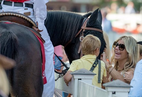 An outrider shares his horse with one of the race patrons that attended the race program at the Saratoga Race Course Sunday Sept. 3,  2023 in Saratoga Springs, N.Y. Photo  by Skip Dickstein