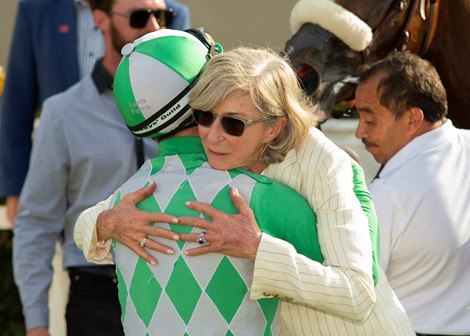 Trainer Carla Gaines, right, has a hug for jockey Umberto Rispoli, left, in the winner&#39;s circle ater Closing Remark&#39;s victory in the Grade II, $250,000 John C. Mabee Stakes, Saturday, September 9, 2023 at Del Mar Thoroughbred Club, Del Mar CA.<br>
&#169; BENOIT PHOTO