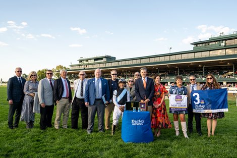 Candied with Luis Saez wins the Darley Alcibiades (G1). Winning connections include Mr and Mrs Todd Pletcher (far left), Dora Delgado (holding Breeders Cup Sign) and Kelsey Marshall Hughes (right holding saddle cloth) Keeneland racing on Oct. 6, 2023.