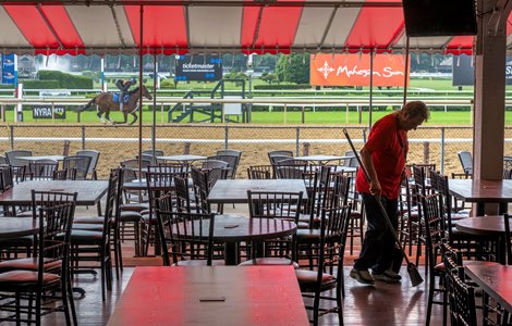 An All Pro Cleaning Services worker puts the finishing touches on the trackside dining area the day before the 2024 season opener at Saratoga Race Course on Wednesday, July 10, 2024 in Saratoga Springs, NY Photo by Skip Dickstein