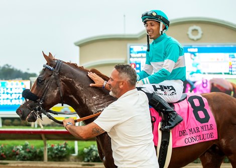Billy Koch of Little Red Feather Racing, bottom, has a moment with Conclude and jockey Hector Berrios after their victory in the Grade II, $300,000 Del Mar Mile, Saturday, August 31, 2024 at Del Mar Thoroughbred Club, Del Mar CA.<br>
© BENOIT PHOTO