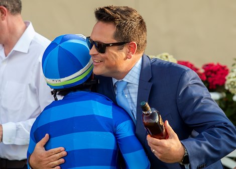 Co-owner Mike Joyce, right, has a hug for jockey Kazusky Kimura, left, in the winner's circle after Hang the Moon's victory in the Grade II, $250,000 John C. Mabee Stakes, Saturday, September 7, 2024 at Del Mar Thoroughbred Club, Del Mar CA. © BENOIT PHOTO