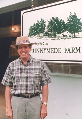 Catesby W. Clay in front of his Runnymede Farm sign