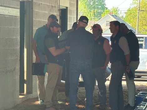 Hall of Fame trainer Todd Peltcher (center) speaks with regulatory veterinarians at his barn at Churchill Downs