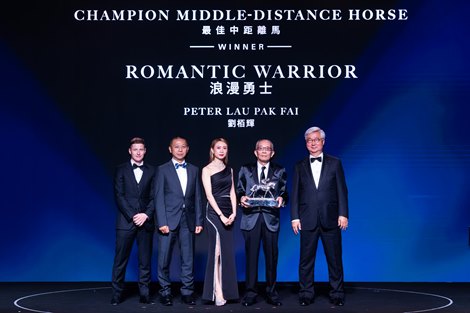 Dr Silas Yang (first from right), Steward, The Hong Kong Jockey Club, presents the Champion Middle-Distance trophy to Peter Lau Pak Fai (second from right), owner of Romantic Warrior; the owner is accompanied by Suki Tang Xianfang (centre), trainer Danny Shum (second from left) and jockey James McDonald (first from left).