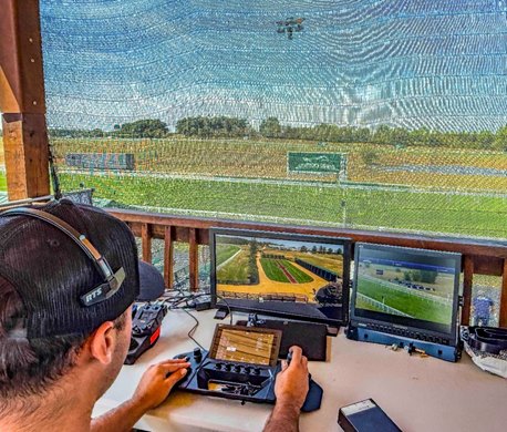Christian Barba tests Kentucky Downs' new cable camera, shown at top of photo