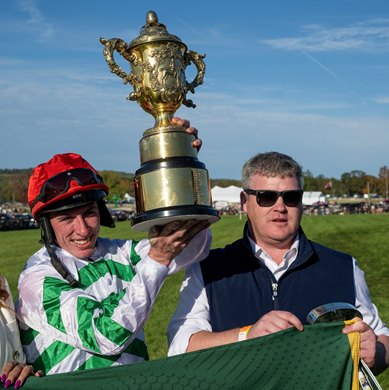 Jack Kennedy, left is all smiles as he holds the winner’s trophy aloft after winning The American Grand National G1 on Zanahiyr at the Far Hills Races Saturday Oct. 18, 2025 in Far Hills, N.J. Kennedy is joined by trainer Gordon Elliott. This was trainer Gordon Elliott’s fifth win on the day and Jack Kennedy’s fourth.  Photo for Far Hills Race Meeting by Skip Dickstein