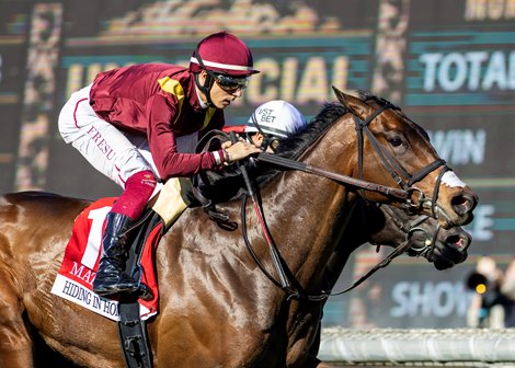Robert La Penta's Hiding in Honduras and jockey Antonio Fresu, outside, collar Tempus Volat and Mirco Demuro, inside, just in time to win the Grade II $100,000 Mathis Mile Stakes Sunday, December 28, 2025, on opening day of the Santa Anita Park meet.<br>
Benoit Photo