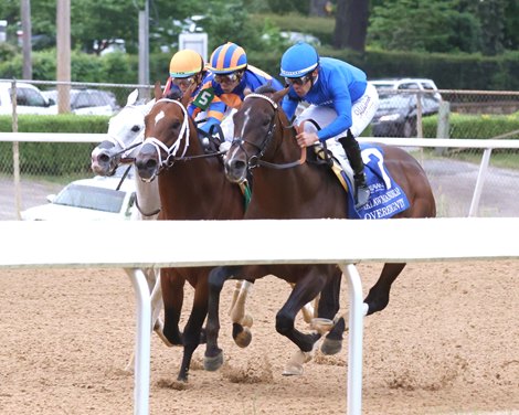 White Abarrio (outside) overtakes Sovereignty (inside) and Journalism (middle) in the final turn to win the 2026 Oaklawn Handicap at Oaklawn Park