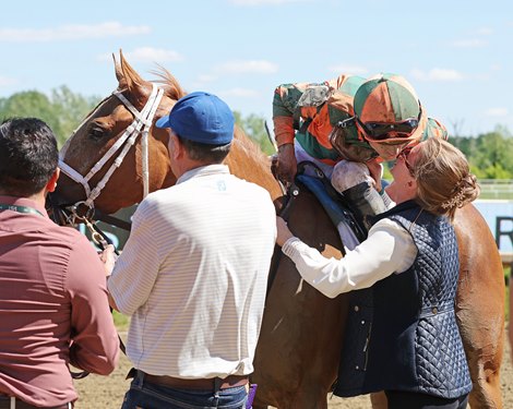 Jockey Sheldon Russell reaches down to kiss his wife Brittany Russell after Peach Tie #2 won the $150,000 Miss Preakness Stakes at Laurel Racecourse on Friday  May 15, 2026. Photo By Bill Denver/EQUI-PHOTO